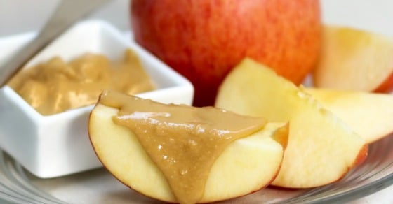 apple slices with a small container of almond butter