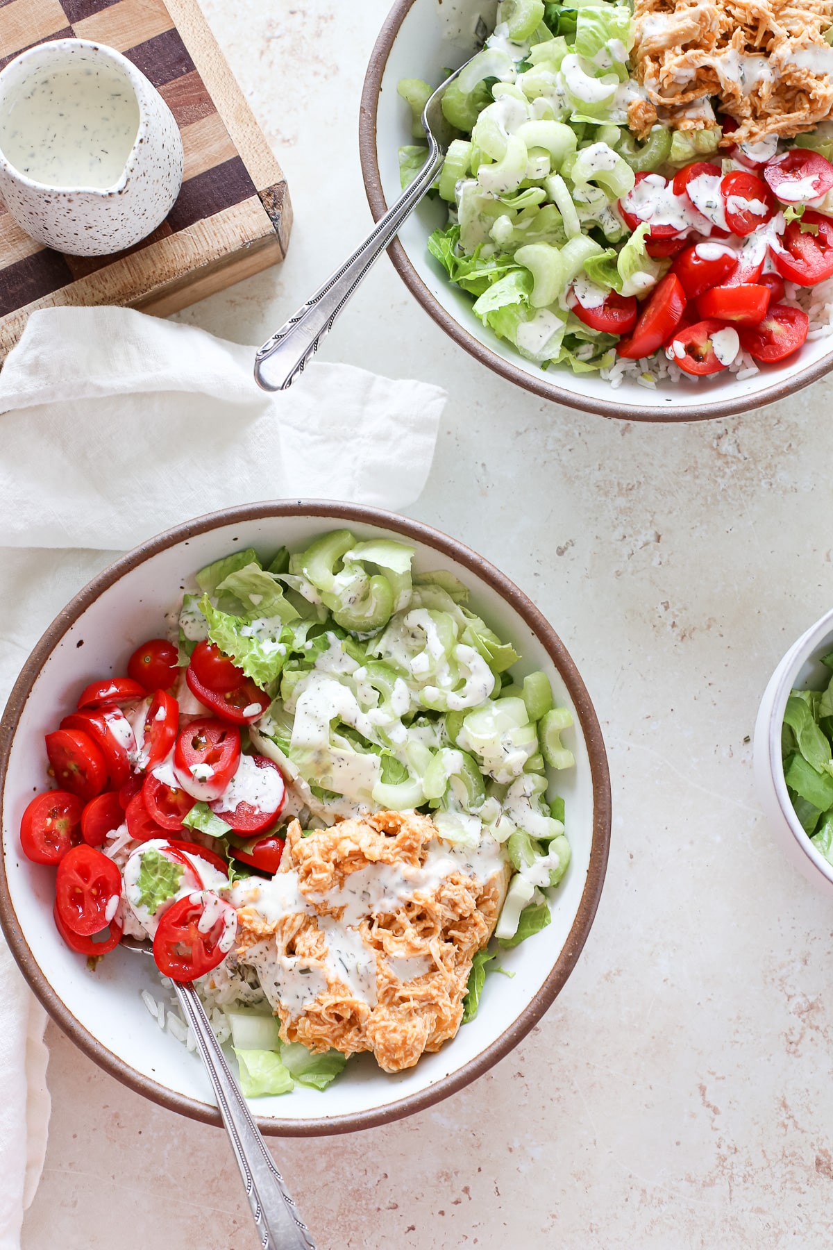 rice bowl topped with shredded chicken and vegetables