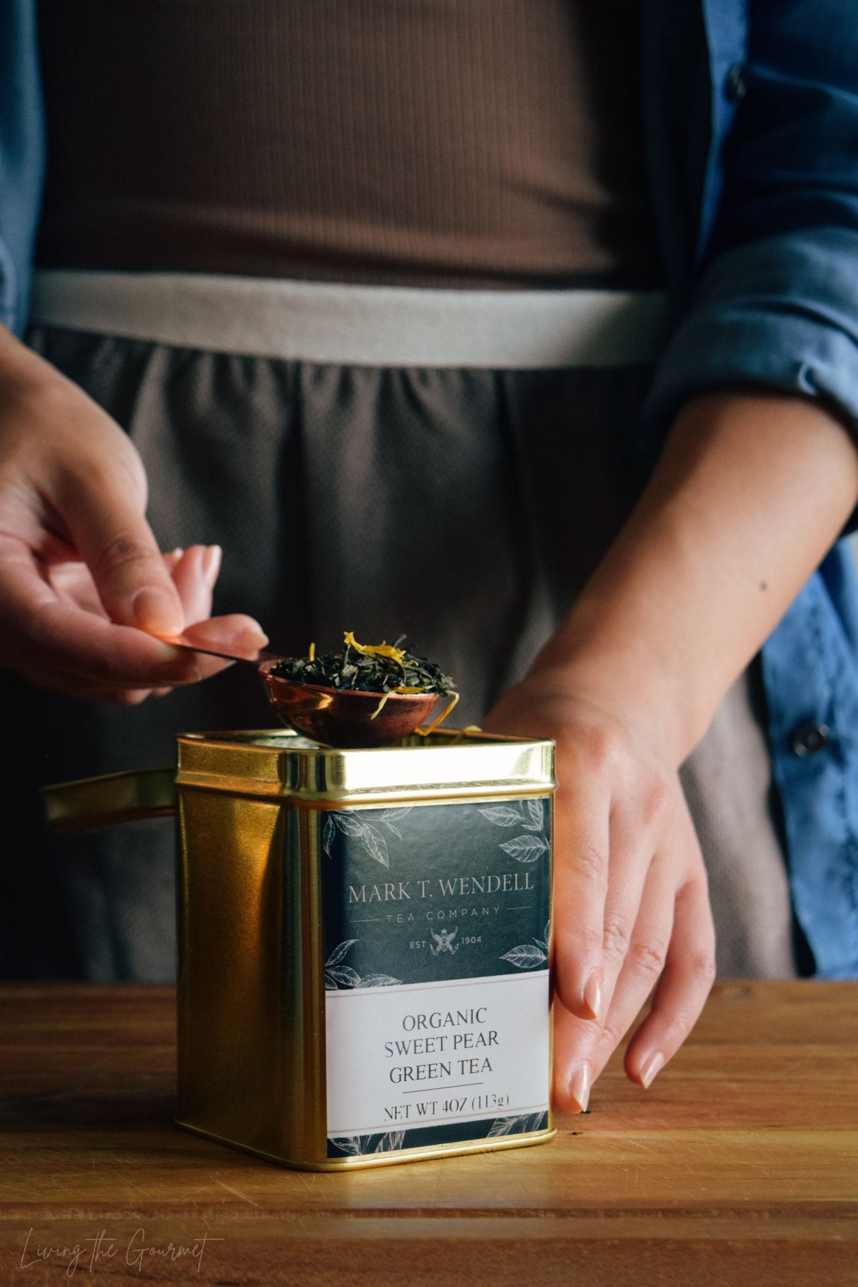 small glass jars of loose leaf tea on a shelf