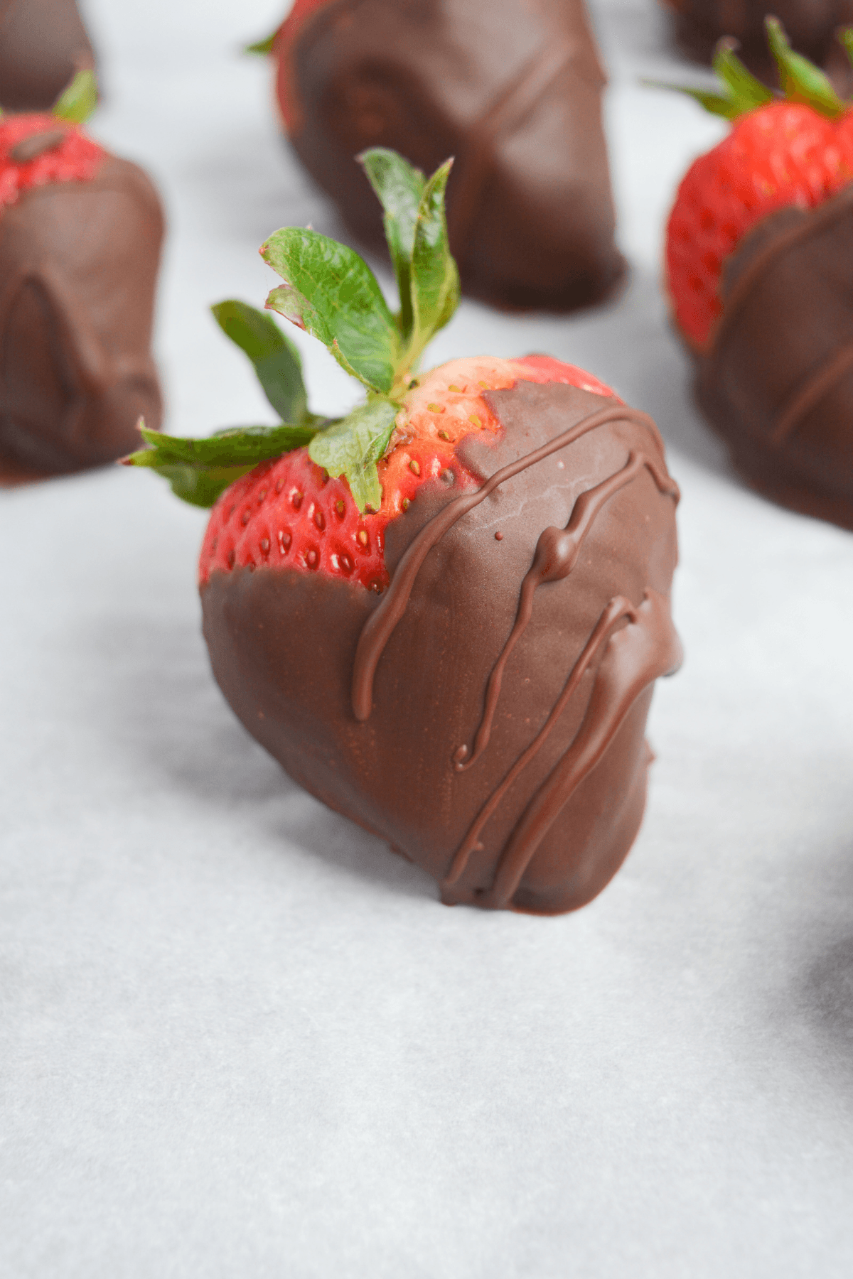 chocolate covered strawberries on parchment paper